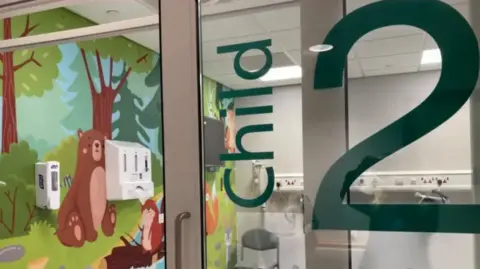 Michelle Lyons / BBC A dedicated childrens bay in a hospital with a mural on the wall.