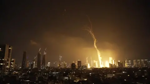 A huge golden light erupts from where an explosion has happened