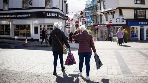 Shoppers wait to cross the high street in Maidstone