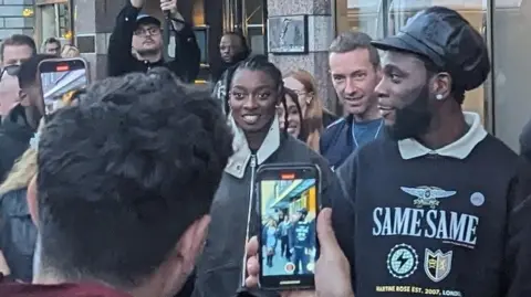 PA Media Coldplay frontman Chris Martin cheered on by fans ahead of the band filming a video in Dublin City centre