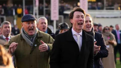 PA Media Two men smartly dressed men with excitable expressions