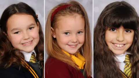 The family publishes the image of Bebe King, Elsie Dot Stancombe and Alice Aguiar. All girls smile in the camera in these professional school photos. They wear school uniforms.
