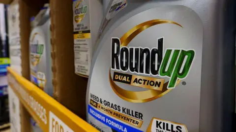 Getty Images Bottles of Roundup weed and grass killer are stacked at a Costco Wholesale store on March 11, 2025 in San Diego, California