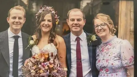 NHS Blood and Transplant handout Nicki Detko's children left to right: Stefan, Mysia, Janek and Zosia grow up. They are dressed up for a wedding and are all smiling.
