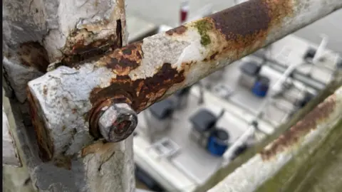 LDRS/Nathaniel Lawson A close up of a part of the bridge that is rusting.