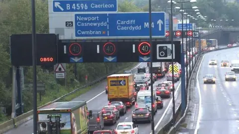 A busy road with a queue of traffic.