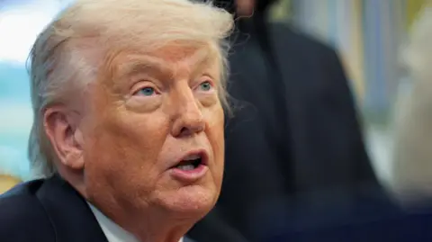 A close-up shows Donald Trump talking, while looking serious.