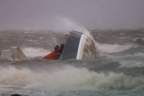 Joe Raedle/Getty Images A capsized boat washes ashore in Saint Petersburg, Florida
