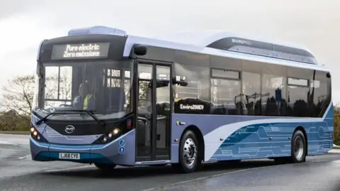 A single-decker bus in a car park.