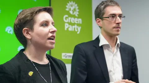 PA MEDIA Green Party co-leaders Carla Denyer and Adrian Ramsay