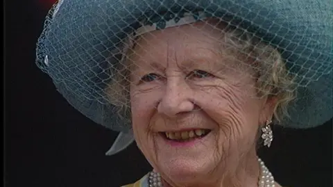 The Queen Mother wearing a hat and smiling