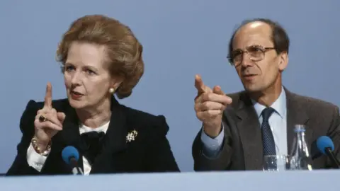 Getty Images Margaret Thatcher sitting next to Norman Tebbit