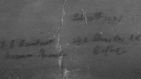 Opus Conservation Cracked area of paint with name and date written on 