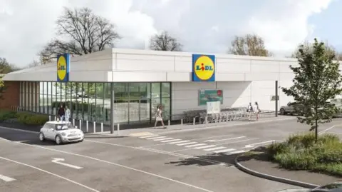 A CGI artist impression of the Lidl store which is a large, white building with a partial glass front on the left side. Two blue and yellow Lidl logo sit on the roof of the roof of the store, one facing the car park on the right, and the other facing a main road on the left. There are cars in the car park and two driving down the road.