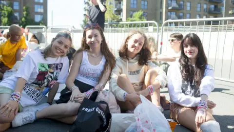 PA Taylor Swift fans Izzie, 18, Sophia, 19, Taylor, 19, and Mary, 27, pose for a photo as they wait to enter Wembley Stadium in London,