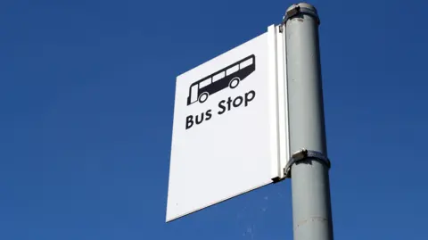 Close up view of a bus stop sign.