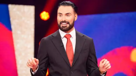 Rylan Clark on stage presenting Comic Relief 2025