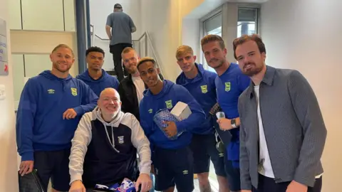 Scott Billison Scott Billison with friend Mark Wall and Ipswich Town players before the Cardiff City match in September