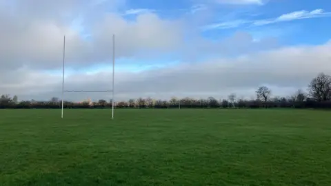The picture shows the current grass pitch at Atherstone Sports Club, which is due to be replaced with a 3G artificial pitch. The current pitch also has rugby goal posts erected