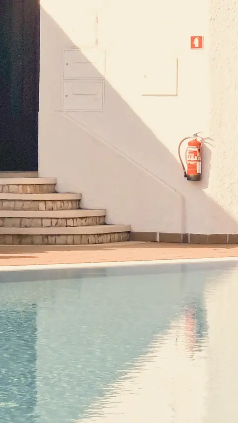 Zoe Hodkinson A swimming pool and steps in shadow