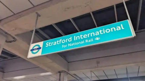 A DLR sign saying Stratford International for national rail. 