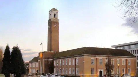 David Dixon/Geograph External view of Salford Civic Centre as the sun is setting.