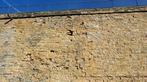 LDRS Part of the castle wall showing gaps in the brick work