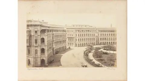 DAG An albumen print depicting Elphinstone Circle (now Horniman Circle), a key commercial and administrative precinct in late-nineteenth century Bombay. Produced by the Bourne & Shepherd studio. 