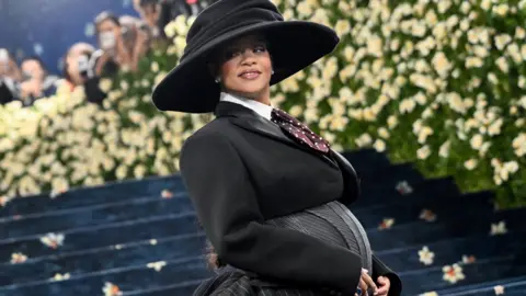 Rihanna on Met Gala red carpet with baby bump showing
