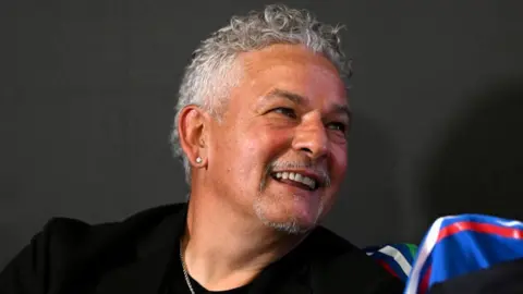 Getty Images Roberto Baggio smiles during a press conference at Centro Tecnico Federale di Coverciano on June 03, 2024 in Florence, Italy. 