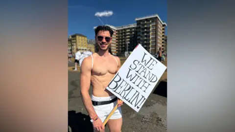 A man with his top off.