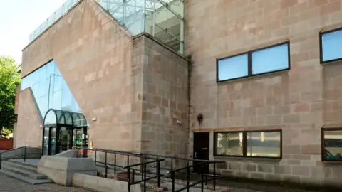 The exterior of large stone court building