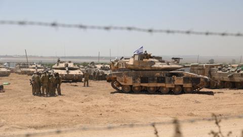 Israeli troops and tanks gather