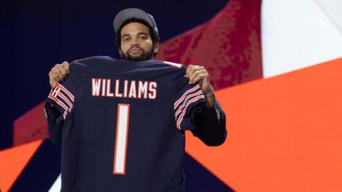 Williams holds his Chicago Bears shirt