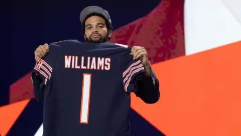 Williams holds his Chicago Bears shirt