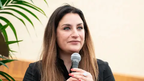Getty Images Baroness Luciana Berger speaking at the Kite Festival in 2022 sitting down and holding a microphone