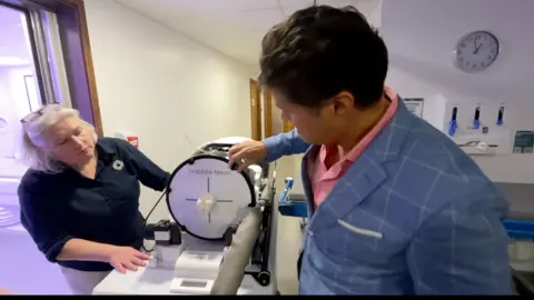 BBC/Mark Norman Professor Ludvic Zrinzo showing how the ultrasound machine works