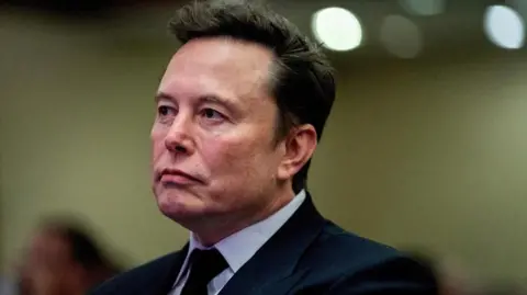 Tesla CEO and X owner Elon Musk listens as US President-elect Donald Trump speaks during a meeting with House Republicans at the Hyatt Regency hotel in Washington, DC, U.S. on November 13, 2024.