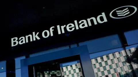 Bank of Ireland front of branch. The sign says Bank of Ireland in white over a dark wall. 