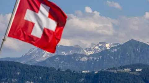 Reuters The Swiss flag flies in front of a view of snow-capped mountains and the hotel where the peace summit took place in Lucerne, Switzerland