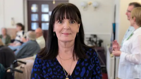 BBC Penny Bailey wearing a blue and black shirt