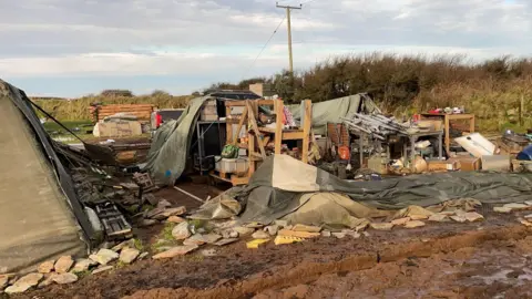 A general view of the Noon Cregg CIC Veterans Retreat showing tents blown over and belongings strewn all over the ground.