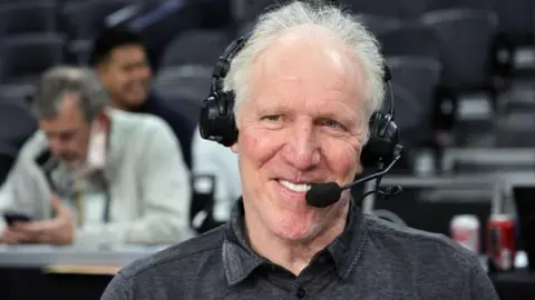 Getty Images Sportscaster and former NBA player Bill Walton broadcasts a game between the UCLA Bruins and the Washington State Cougars during the Pac-12 Conference basketball tournament quarterfinals at T-Mobile Arena on March 10, 2022 in Las Vegas, Nevada.