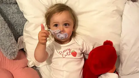 Supplied Ottilie in with a thumb up and dummy in her mouth 
