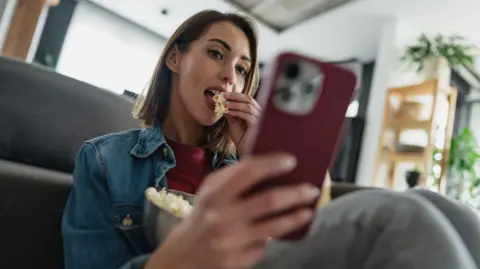 Stock photo of woman on smartphone.