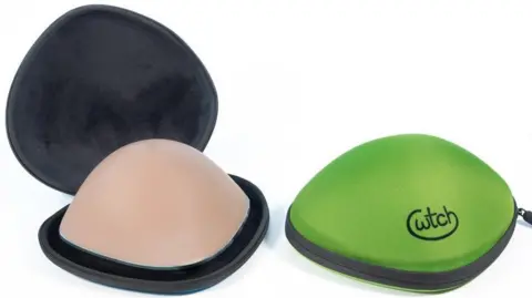 The picture depicts the oval shaped "Cwtch Case" opened and closed. On the left is the case open - with black lining and a flesh coloured prosthesis inside. One the right is the case closed. It's neon green in colour and has a black closed zip with "Cwtch" written in black writing.