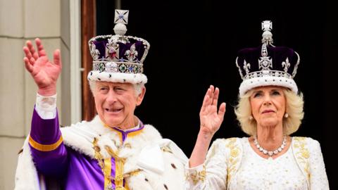 King Charles III and Queen Camilla on the balcony of Buckingham Palace following the coronation of King Charles III and Queen Camilla at Westminster Abbey, London.