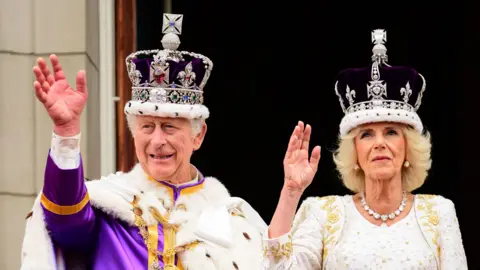 PA King Charles III and Queen Camilla on the balcony of Buckingham Palace following the coronation of King Charles III and Queen Camilla at Westminster Abbey, London.