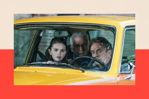 XNY/Star Max/GC Images A still of 'Only Murders in the Building'. Three characters pose in a taxi.