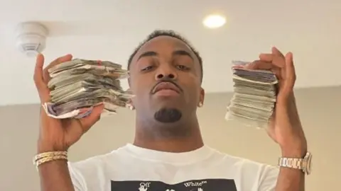 Davante James is holding wads of cash